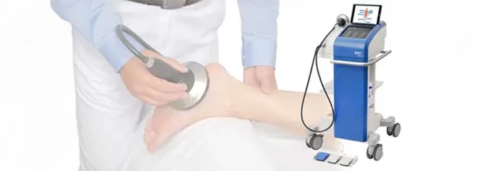 Chiropractor Rockville MD Softwave A practitioner using softwave therapy on a patient's foot